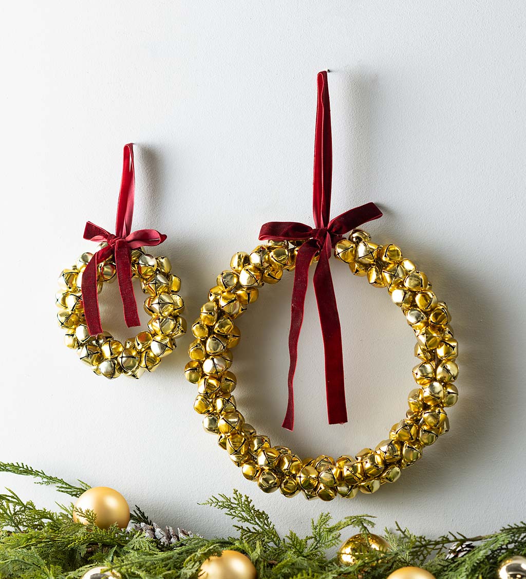 Two gold christmas jingle bell with red ribbon Vector Image